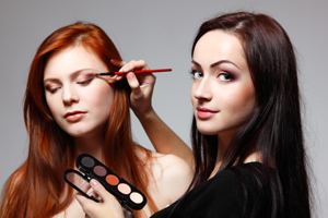 Portrait of beautiful young redheaded woman with esthetician making makeup eye shadow. Lorem ipsum dolor sit amet, consectetur adipiscing elit. Ut elit tellus, luctus nec ullamcorper mattis, pulvinar dapibus leo. Lorem ipsum dolor sit amet, consectetur adipiscing elit. Ut elit tellus, luctus nec ullamcorper mattis, pulvinar dapibus leo