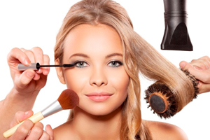 Professional makeup artist and hairdresser are preparing a fashion model. Portrait of beautiful blonde girl with blue eyes.
Isolated on white background